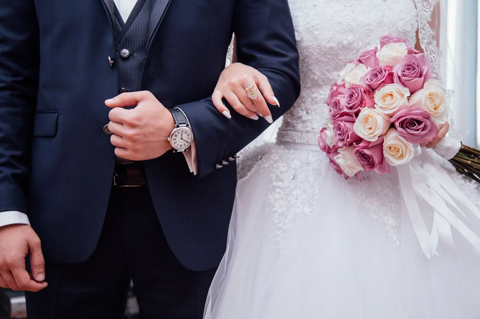 A bride and groom walking arm in arm